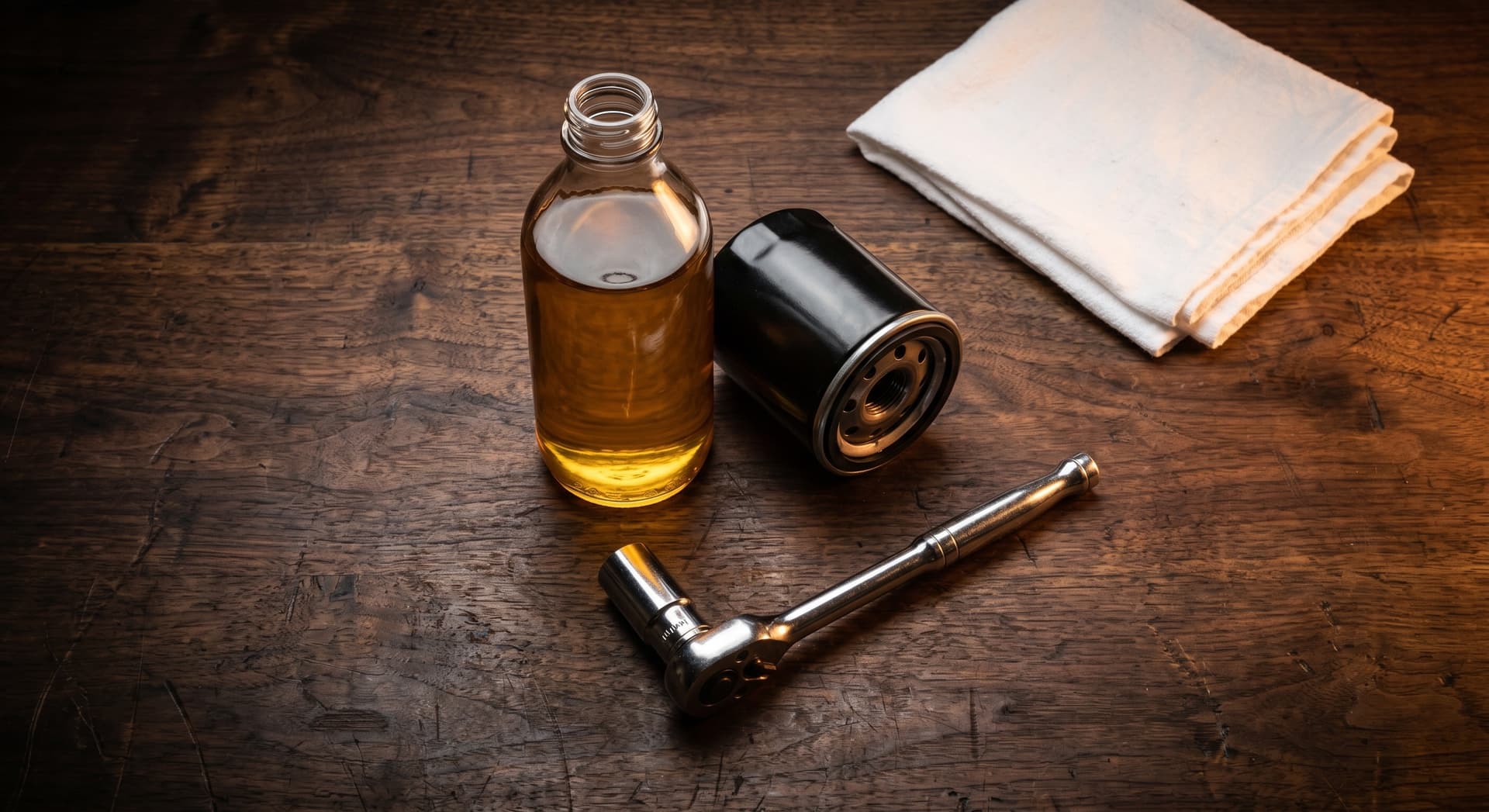 Close-up of clean amber synthetic motor oil being poured into an engine during an oil change
